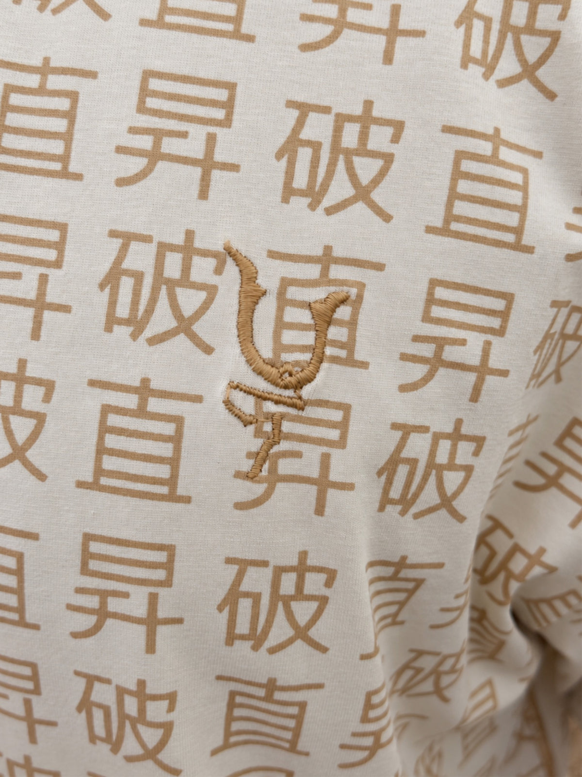 JSYM Tee chest embroidery detail
